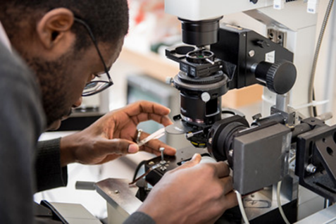 Man working with microscope