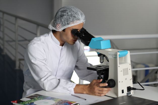 Researcher with microscope